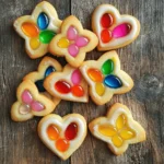 - 2 3/4 cups all-purpose flour - 1 teaspoon baking powder - 1/2 teaspoon salt - 1 cup unsalted butter, softened - 1 1/2 cups granulated sugar - 1 large egg - 1 teaspoon vanilla extract - 1/2 teaspoon almond extract - 1 cup crushed hard candies (various colors) - Optional: edible glitter for decoration Using unsalted butter is key for flavor control. It allows you to manage the salt in your recipe. Salted butter can make your cookies too salty. Always choose unsalted butter for baking. Hard candies bring the stained glass look to life. When they melt, they fill the cookie's center with vibrant color. Choose a mix of colors for a fun effect. You can use any hard candy you like. Just crush them into small pieces. The smaller the pieces, the better they melt. This will give you a stunning stained glass effect in your cookies. These ingredients set the stage for your delightful stained glass sugar cookies. For the full recipe, refer to the provided details. 1. Preheat your oven to 350°F (175°C). This step is key to baking cookies evenly. 2. Line two baking sheets with parchment paper. This makes cleanup a breeze later. 3. In a medium bowl, mix together 2 3/4 cups of flour, 1 teaspoon of baking powder, and 1/2 teaspoon of salt. Use a whisk to combine them well. Set this bowl aside. 4. In a large bowl, beat 1 cup of softened unsalted butter with 1 1/2 cups of granulated sugar. Mix until it is light and fluffy. This should take about 3 to 4 minutes. 5. Add in 1 large egg, 1 teaspoon of vanilla extract, and 1/2 teaspoon of almond extract. Mix again until everything is well blended. 6. Gradually add the dry ingredients to the wet mixture. Stir gently until just combined. Remember, do not overmix! 7. Divide the dough in half. Wrap each half in plastic wrap and chill them in the refrigerator for at least 1 hour. Chilling helps the cookies hold their shape. 1. After chilling, take one half of the dough from the fridge. Roll it out on a lightly floured surface to about 1/4 inch thick. 2. Use cookie cutters to cut out shapes from the dough. Make sure to cut a hole in the center of each cookie. This hole will hold the candy filling. 3. Place the cut-out cookies onto the prepared baking sheets. Leave a little space between them for baking. 1. Fill the holes in the cookies with crushed hard candies. Use different colors for a fun stained glass look. 2. Bake the cookies in the preheated oven for about 8 to 10 minutes. The edges should be firm, but the centers can stay soft. 3. Let the cookies cool on the baking sheet for 5 minutes. Then, transfer them to a wire rack to cool completely. This helps them become crisp and tasty. To get the best stained glass look, choose the right candies. I love using hard candies like Jolly Ranchers or Life Savers. Crush them into small pieces, but not too fine. If they are too small, they will melt away. Fill the cookie holes with the candy pieces, but don’t overfill them. This helps keep the candy from spilling over. To prevent cookies from spreading, chill the dough well. After mixing, wrap the dough and refrigerate for at least one hour. This helps the cookies hold their shape while baking. Also, use parchment paper on your baking sheets. It keeps the cookies from sticking and helps them bake evenly. Garnishing your stained glass cookies with edible glitter adds a fun touch. Just sprinkle some on after baking, while the cookies are still warm. The heat helps the glitter stick. You can also use colored sugar for a sparkly effect. For serving, display the cookies on a decorative plate. You can add colorful ribbons around the plate for a festive look. Arrange the cookies in groups by color for a stunning effect. This makes them eye-catching and fun to enjoy. {{image_4}} You can change the flavor of your stained glass sugar cookies easily. Swap the vanilla extract for peppermint extract for a fresh twist. Orange extract adds a bright, citrus flavor, great for a sunny day. You can even mix a few drops of almond extract for extra depth. When it comes to candy, the options are endless! Hard candies like Jolly Ranchers or Lifesavers work best. Try using different colors to make your cookies pop. You can even mix flavors, like cherry and lemon, for a fun surprise inside. Each cookie can tell a different sweet story! If you need a gluten-free option, use a gluten-free flour blend. Many blends work well in cookies. Just choose one that has a good taste and texture. You can also add a bit of xanthan gum to help with the structure. For a vegan version, replace the butter with coconut oil or a vegan butter. Use flaxseed meal mixed with water instead of an egg. This mix creates a good binding agent. Your cookies will still be tasty and fun to eat! Explore these variations and make your stained glass sugar cookies unique! For the full recipe, check the link above. To keep your stained glass sugar cookies fresh, store them in an airtight container. This helps retain their flavor and moisture. If you use wax paper between layers, it prevents sticking. For long-term storage, you can freeze these cookies. Wrap them tightly in plastic wrap and place them in a freezer-safe bag. This method keeps them fresh for up to three months. These cookies taste best within one week. After that, they may start to lose their soft texture. You’ll know they are stale if they feel hard or dry. If you notice any off smells or colors, it's best to discard them. Enjoying these cookies fresh ensures you get the full stained glass effect! How do I prevent my cookies from spreading? To stop cookies from spreading, chill your dough. A cool dough firms up. This helps keep the cookie shape. Also, use parchment paper. It prevents sticking and gives a better bake. Make sure you measure flour correctly. Too little can cause spreading. Can I use different types of candies for the stained glass effect? Yes, you can use many kinds of candies! Hard candies work best. Try different colors for fun designs. You could use Jolly Ranchers, Life Savers, or any hard candy you like. Just crush them well before using. The more colorful, the better! What to do if the cookies are too soft? If your cookies are too soft, chill the dough longer. A firmer dough bakes better. If they bake and still seem soft, check your oven temp. An oven thermometer helps ensure it's accurate. You can also bake them a minute or two longer. Why did my candies not melt properly? Candies may not melt if they are too thick. Make sure to crush them finely. Uneven pieces will melt differently. Also, check your baking time. If they are not melted after baking, put them back in for a minute. Keep a close eye on them! Best occasions to serve stained glass sugar cookies These cookies shine during holidays! Use them for Christmas, birthdays, or any festive gathering. They also make great gifts. Their bright colors and fun shapes please everyone. Kids love making and eating them too! Pairing ideas with beverages or other desserts Serve these cookies with warm milk or hot cocoa. They also taste great with tea or coffee. For dessert, pair them with vanilla ice cream. The cold ice cream and sweet cookie complement each other well. For the full recipe, check out the earlier section! You've learned how to make stained glass sugar cookies with detailed steps and tips. Starting with key ingredients like unsalted butter and hard candies ensures great results. By following the preparation and baking techniques, you can achieve the perfect texture. Don't forget to explore flavor variations and dietary options. Proper storage helps maintain freshness, while our FAQs address common concerns. Enjoy baking and sharing these beautiful cookies at your next gathering!