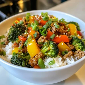 - 1 lb ground turkey - 2 cups cooked jasmine rice - 1 bell pepper, diced - 1 cup broccoli florets - 1 small onion, finely chopped - 3 cloves garlic, minced - 2 tablespoons low-sodium soy sauce - 1 tablespoon sesame oil - 1 teaspoon fresh ginger, grated - 1 teaspoon black pepper - Salt to taste - Garnishes: green onions, sesame seeds For this savory ground turkey rice bowl, you need fresh and simple ingredients. Ground turkey gives the dish a lean protein base. Jasmine rice adds a fluffy, fragrant touch. Diced bell pepper and broccoli bring in crunch and color. Using onion and garlic creates a rich aroma that fills your kitchen. The soy sauce, sesame oil, and ginger combine to give a savory depth. Make sure to adjust the salt to your taste. Fresh green onions and sesame seeds make great garnishes. They add a pop of flavor and a nice finish. Gather all these ingredients before starting. You will enjoy this quick and healthy meal that is easy to make. {{ingredient_image_2}} - Heat 1 tablespoon of sesame oil in a large skillet over medium heat. - Add 1 small onion, finely chopped, and sauté for 3-4 minutes until translucent. - Mix in 3 cloves of minced garlic and 1 teaspoon of grated ginger. Cook for 1-2 minutes until fragrant. - Raise the heat to medium-high and add 1 pound of ground turkey. Cook for 5-7 minutes until browned and no longer pink. - Stir in 1 diced bell pepper and 1 cup of broccoli florets. Cook for 4-5 minutes until the veggies soften but stay bright. - Pour in 2 tablespoons of low-sodium soy sauce. Add black pepper and salt to taste. Mix well. - Heat through for 2-3 minutes, stirring occasionally, then remove from heat. - Serve by scooping 2 cups of cooked jasmine rice into bowls. Top with the turkey and veggie mix. - Garnish with chopped green onions and a sprinkle of sesame seeds. - To ensure the turkey is cooked through, use a meat thermometer. Aim for 165°F. - For vibrant and crisp vegetables, don’t overcook. Stir frequently and watch closely. - Plate the dish in colorful bowls for a fun look. - Add a sliced lime on the side for a fresh twist and a pop of color. - Consider serving with a side of steamed edamame or a simple salad for extra crunch. To make your Savory Ground Turkey Rice Bowl just right, adjust the seasonings. If you love salt, add a bit more soy sauce. For a touch of sweetness, try a dash of honey or brown sugar. If you want a kick, add red pepper flakes or hot sauce. Fresh herbs like cilantro or basil can lift your dish too. Feel free to mix and match spices based on what you enjoy. Cooking jasmine rice can be simple. Rinse the rice under cold water until the water runs clear. This removes the starch and keeps the rice fluffy. Use a ratio of 1 cup rice to 1.5 cups water. Bring it to a boil, then cover and simmer on low for about 15 minutes. For quick cooking, an Instant Pot works well. Just use the same water-to-rice ratio and set it for 4 minutes on high pressure. Ground turkey is a great choice for this meal. It is leaner than beef and has less fat. It is high in protein, which keeps you full longer. Pair it with greens like broccoli, bell peppers, or spinach. This adds vitamins and makes your meal colorful. Aim for half your bowl to be filled with veggies. This way, you balance flavors and boost nutrition. Pro Tips Use Fresh Ingredients: The flavors of your dish will greatly improve when using fresh vegetables and herbs. Opt for organic produce if possible for the best taste. Customize Your Veggies: Feel free to swap in your favorite vegetables or whatever you have on hand. Carrots, snap peas, or zucchini can all be delicious alternatives. Make It Spicy: If you enjoy a bit of heat, add some red pepper flakes or a dash of sriracha to the turkey mixture while cooking to elevate the flavor profile. Meal Prep Friendly: This dish stores well in the fridge, making it a great option for meal prep. Simply reheat and enjoy throughout the week for quick and satisfying meals. {{image_4}} You can easily switch out vegetables in this rice bowl. Try using: - Zucchini, diced - Carrots, shredded - Snap peas, trimmed These options add color and flavor. They also keep the dish fresh and fun. For the soy sauce, you can use: - Tamari, which is gluten-free - Coconut aminos, for a sweeter taste These alternatives can suit your taste or dietary needs. To make this dish gluten-free, choose tamari instead of soy sauce. This small change keeps the flavor strong while meeting dietary needs. For vegetarian or vegan adaptations, you can replace ground turkey with: - Crumbled tofu, which absorbs flavors well - Lentils, cooked and seasoned to taste These swaps maintain the protein while making the dish plant-based. You can also change the flavor to fit regional styles. For a Thai twist, add: - Red curry paste - Lime juice for zest For a Japanese-style rice bowl, consider adding: - Mirin for sweetness - Nori strips for crunch You can play with different sauces or toppings like sriracha or hoisin sauce. Each choice transforms the dish into something new and exciting. To keep your Savory Ground Turkey Rice Bowl fresh, store it in the fridge. Use airtight containers to prevent moisture loss and keep flavors intact. Glass or plastic containers with tight lids work best. Make sure to cool the dish slightly before sealing it up. This helps avoid condensation, which can make the food soggy. When reheating, use a microwave or a skillet. For the microwave, place the dish in a bowl and cover it with a damp paper towel. Heat on medium power for 1-2 minutes, stirring halfway through. If you use a skillet, add a splash of water to help steam the dish back to life. For freezing, let the bowl cool completely, then place it in a freezer-safe container. To thaw, transfer it to the fridge overnight before reheating. In the fridge, your Savory Ground Turkey Rice Bowl lasts about 3-4 days. If you freeze it, it can keep for up to 3 months. Always check for signs of spoilage before eating. Look for changes in smell, texture, or color. If it smells off or looks strange, it’s best to toss it. What type of ground turkey is best for this recipe? I recommend using lean ground turkey. This keeps the dish healthy without too much fat. Lean turkey also absorbs flavors well and cooks quickly, making it perfect for your rice bowl. Can I use brown rice instead of jasmine rice? Yes, you can use brown rice! It adds a nutty taste and more fiber. Just remember that brown rice takes longer to cook. If you choose brown rice, adjust the cooking time for the overall dish. How do I make this dish spicy? To add spice, include red pepper flakes or diced jalapeños. You can also use sriracha sauce for a kick. Start with a little, then taste and add more if you like it hotter. Can I substitute the sesame oil? Yes, you can use olive oil or avocado oil instead. These oils will change the flavor slightly but still work well in the dish. Just use the same amount. What vegetables can I add for extra nutrition? Feel free to add spinach, carrots, or snap peas. These veggies add color and nutrients. You can mix and match based on what you have at home. How long does it take to prepare and cook? The total time is about 20 minutes. You can prep the ingredients in about 10 minutes. Cooking the dish takes another 10 minutes. Tips for quicker meal prep on busy days Chop your veggies ahead of time and store them in the fridge. You can also cook extra rice earlier in the week. This way, you can whip up your turkey rice bowl in no time! This blog post shared a simple and tasty ground turkey rice bowl recipe. You learned about the key ingredients, step-by-step cooking, and helpful tips. We also explored variations and storage suggestions to make the dish your own. Incorporating these ideas will boost your cooking skills and make meal prep easier. By customizing flavors and exploring alternatives, you can create a dish that suits your taste and dietary needs. Enjoy trying out this recipe and making it uniquely yours!