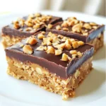 - 1 cup creamy peanut butter - 1 cup rolled oats - 1/2 cup honey or maple syrup - 1/2 cup powdered sugar - 1/2 cup dark chocolate chips - 1/4 cup coconut oil - 1/4 tsp salt - 1/2 tsp vanilla extract - Optional: 1/4 cup chopped nuts (e.g., almonds or walnuts) To make these no-bake peanut butter bars, you need some simple ingredients. First, creamy peanut butter is a must. It gives the bars their rich flavor and smooth texture. Next, rolled oats add a hearty bite and help bind the bars together. For sweetness, you can use honey or maple syrup. Both options work well, but honey has a stronger flavor. Powdered sugar adds a light sweetness too. This mix makes a great base for the bars. To take these bars to the next level, I love adding dark chocolate chips. They melt perfectly and create a smooth topping. Coconut oil helps the chocolate set and adds a nice gloss. Just a pinch of salt boosts the flavor and balances the sweetness. Lastly, vanilla extract adds a warm note to the mix. If you want extra crunch, consider folding in chopped nuts. Almonds or walnuts work great, but feel free to use your favorite. Each bite will be packed with flavor and texture! {{ingredient_image_2}} Line an 8x8-inch baking dish with parchment paper. This makes it easy to lift the bars later. Leave some paper hanging over the sides for a smooth removal. In a large bowl, mix 1 cup of creamy peanut butter, 1/2 cup of honey, 1/2 cup of powdered sugar, 1/4 teaspoon of salt, and 1/2 teaspoon of vanilla extract. Use a sturdy spatula to mix until smooth and well combined. Gradually stir in 1 cup of rolled oats. Make sure every oat gets coated in the peanut butter mix. If you want extra crunch, fold in 1/4 cup of chopped nuts like almonds or walnuts. Spoon the mixture into your lined baking dish. Press it down firmly with a spatula or your hands. Ensure the layer is even across the bottom. In a microwave-safe bowl, add 1/2 cup of dark chocolate chips and 1/4 cup of coconut oil. Microwave in 20-second bursts, stirring well after each time, until the mixture is smooth and melted. Pour the melted chocolate over the pressed peanut butter layer. Use a spatula to spread the chocolate evenly over the top. Place the dish in the fridge and chill for at least 2 hours. This helps the bars set and become firm. For the best bars, use creamy peanut butter. Creamy peanut butter gives a smooth base. It helps the bars hold together well. If you prefer a crunch, use crunchy peanut butter. Crunchy peanut butter adds fun bits in every bite. Both types work, but creamy is my go-to. You can easily add flavor to your bars. Try mixing in cocoa powder for a chocolate twist. A little cinnamon or nutmeg can make them warm and cozy. If you love coconut, add some shredded coconut. For a nutty crunch, chopped nuts like almonds or walnuts are great too. These add-ins make every bite more exciting! Serving your bars can be fun and creative. Try slicing them into fun shapes for kids. You can serve them with fresh fruit like bananas or strawberries. Arrange them on a pretty platter for guests. Drizzle extra melted chocolate on top for a fancy touch. Each way makes them look and taste even better! Pro Tips Use Natural Peanut Butter: Opt for natural peanut butter without added sugars or oils for a healthier version of these bars. Chill for Best Results: Allow the bars to chill for longer than 2 hours if you want them to be extra firm and easier to cut. Customize with Add-Ins: Feel free to add in dried fruits or seeds for additional flavor and texture. Store Properly: Keep the bars in an airtight container in the refrigerator for up to a week for maximum freshness. {{image_4}} You can easily make these bars vegan and gluten-free. Use maple syrup instead of honey. For a gluten-free option, choose certified gluten-free oats. These simple swaps keep the bars tasty and safe for many diets. Want to mix it up? Add some fun ingredients! You can include coconut flakes for a tropical touch. Dried fruits like raisins or cranberries also add sweetness and chewiness. Just adjust the mix to your taste! If you need a nut-free option, use sunbutter or soy nut butter instead of peanut butter. These seed butters work just as well and keep the bars creamy. They also offer a unique flavor twist that everyone can enjoy. To keep your no-bake peanut butter bars fresh, store them in the refrigerator. Place them in an airtight container or wrap them tightly in plastic wrap. If you want to save some for later, you can freeze them. Just cut the bars into pieces first, then layer them between parchment paper in a freezer-safe bag or container. When stored properly, these bars last about one week in the fridge. If frozen, they can stay good for up to three months. This makes them great for meal prep or snacks whenever you need a quick treat. If you freeze the bars, let them thaw in the fridge overnight. For a quick snack, you can take them out and enjoy them cold. These bars taste great chilled, so there’s no need to heat them up. If you want some fun, drizzle a bit of melted chocolate on top before serving. Yes, you can use natural peanut butter. Natural peanut butter has less sugar and no added oils. It gives a richer flavor and creamier texture. Just remember to stir it well before use. The oil may separate, so mix it back in for a smooth consistency. These bars need to chill for at least 2 hours. This time allows the bars to firm up. The longer they chill, the firmer they become. I recommend checking after 2 hours. If they feel soft, give them more time in the fridge. Yes, you can add protein powder. It boosts nutrition and keeps you full longer. Start with 1/4 cup of protein powder. You may need to adjust the honey or peanut butter for balance. Make sure the mixture stays sticky enough to hold together. Definitely! These bars are very kid-friendly. They taste sweet and nutty, which kids love. The oats provide fiber, and peanut butter offers protein. You can even let kids help make them. It’s a fun, easy treat that they will enjoy. In this post, we explored how to make no-bake peanut butter bars. We covered the main ingredients, mixing steps, and tips for the best texture. You can try different flavors or keep it simple. Remember to store your bars properly to maintain freshness. These treats are easy, tasty, and fit many diets. Now, you can enjoy making them for yourself or share with family and friends. Happy cooking!
