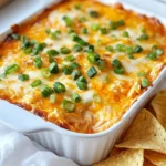 - 2 cups shredded cooked chicken - 8 oz cream cheese - 1/2 cup shredded sharp cheddar cheese - 1/2 cup shredded mozzarella cheese - 1/2 cup buffalo hot sauce - 1/4 cup ranch dressing - 1 green onion (for garnish) - Tortilla chips or sliced veggies for serving Alternative chicken options: You can use rotisserie chicken for ease. If you want a lighter option, try shredded turkey. Cheese variations: Feel free to swap in pepper jack for an extra kick. For a creamier dip, mix in some goat cheese. Healthier sauce alternatives: If you want less heat, use a milder hot sauce. You can also use yogurt instead of ranch for a lighter dip. {{ingredient_image_2}} 1. Preheat your oven to 350°F (175°C). This heat sets the stage for perfect dip. 2. In a large bowl, add the softened cream cheese. Pour in the buffalo hot sauce and ranch dressing. Blend these with a spatula or mixer until smooth. 1. Gently fold in the shredded cooked chicken. Then, add the sharp cheddar and mozzarella cheeses. Mix well, ensuring no clumps remain. 2. Carefully transfer the creamy mixture into a baking dish. Spread it evenly across the bottom. 1. Place the dish in your preheated oven. Bake for 20-25 minutes. Look for bubbling edges and a light golden top. 2. Once done, take it out and let it cool for about 5 minutes. This helps it set for serving. To make Spicy Buffalo Chicken Dip, you need a few good tools: - A large mixing bowl - A spatula or electric mixer - A baking dish These tools help you mix the dip well and bake it evenly. For a creamy dip, ensure your cream cheese is soft. Let it sit at room temperature for about 30 minutes before mixing. This helps it blend smoothly with the hot sauce and ranch dressing. For the best experience, serve your dip with: - Crispy tortilla chips - Fresh veggie sticks (like carrots, celery, and bell peppers) These add color and crunch. When you present your dip, use a bright platter. Serve it right from the baking dish for a rustic feel. Add extra cheese or sliced chili peppers on top for a festive look. Aim to prepare the dip about 30 minutes before you want to serve it. This gives you time to bake and cool it slightly. If you want to make the dip ahead of time, mix it up to a day before. Store it in the fridge, then bake it just before your guests arrive. This saves you time and keeps the dip fresh. Pro Tips Use Rotisserie Chicken: For a quick and flavorful option, grab a rotisserie chicken from the store. It saves time and adds great taste! Adjust the Heat: Feel free to adjust the amount of buffalo hot sauce to suit your spice preference. Start with less and add more if you like it extra zesty! Mix Cheeses: Experiment with different cheese blends, like pepper jack for a spicy kick or gouda for a smoky flavor, to elevate your dip. Make Ahead: Prepare the dip a day in advance and store it in the refrigerator. Just pop it in the oven when you’re ready to serve! {{image_4}} To make a meatless version of spicy buffalo chicken dip, simply swap out the chicken. Use 2 cups of shredded jackfruit or 1 can of chickpeas. These options add texture while keeping the flavor. For a cheesy touch, add 1/2 cup of crumbled feta or a vegan cheese alternative. The buffalo sauce and ranch dressing will still give it that kick! You can lighten up this dip easily. Consider using low-fat cheese options. Try low-fat cream cheese and shredded cheeses. They taste great but cut down on calories. Another smart swap is Greek yogurt for cream cheese. It adds protein and reduces fat. Mix it in with the buffalo sauce and ranch for a creamy base. Want to elevate your dip? Add spices or herbs for extra depth. Try a teaspoon of garlic powder or smoked paprika. Fresh herbs like parsley or cilantro brighten the flavor too. You can also experiment with different hot sauces. A chipotle sauce adds a smoky touch, while a sweet chili sauce gives a nice balance. To keep your spicy buffalo chicken dip fresh, use airtight containers. Glass containers work best. They prevent spills and retain flavor. Before storing, let the dip cool to room temperature. This helps avoid condensation. You can refrigerate your dip for up to three days. If you want to save it longer, freeze it. Place the dip in a freezer-safe container. It can last for up to three months in the freezer. When reheating, the oven gives the best results. Preheat your oven to 350°F (175°C). Place the dip in an oven-safe dish and cover it with foil. Heat for about 20 minutes or until hot. You can also use the microwave for quick reheating. Use a microwave-safe bowl, and heat in short bursts. Stir in between to keep it creamy. Add a splash of ranch or cream cheese if it seems too thick. The dip stays good in the fridge for about three days. If it smells sour or has a strange color, it’s time to toss it. Look for mold or separation in the dip. These are clear signs it has gone bad. Always trust your senses. Freshness is key for this tasty snack! Can I make this dip in a slow cooker? Yes, you can use a slow cooker for this dip. Just mix all the ingredients in the slow cooker. Set it on low for about 2-3 hours. Stir occasionally for a smooth blend. This method keeps the dip warm, making it great for parties. What can I serve with spicy buffalo chicken dip? You can serve this dip with various items. Tortilla chips are a classic choice. Fresh veggies like carrots, celery, and bell peppers are also great. You can use pita chips or even bread slices. The options are endless! Is this recipe gluten-free? Yes, the dip itself is gluten-free. However, be sure to check the labels for the hot sauce and ranch dressing. Some brands may add gluten. Pair it with gluten-free chips or veggies for a fully gluten-free snack. Can I make it dairy-free? You can make a dairy-free version! Use dairy-free cream cheese and cheese alternatives. Many brands offer good substitutes. Check for dairy-free ranch dressing as well to complete your dip. How to adjust spice levels for milder taste? To make the dip milder, use less buffalo sauce. Start with a quarter cup and taste as you go. You can also mix in more cream cheese or a bit of sour cream to tone down the heat. Can I make this dip in advance? Yes, you can prepare the dip ahead of time. Mix all the ingredients and store them in the fridge. Bake it just before serving. This way, you have a warm dip ready to enjoy! This article covered a tasty buffalo chicken dip recipe and its many options. You learned about ingredients, step-by-step instructions, and tips for the best results. Don’t forget the variations like vegetarian and healthier alternatives to suit your needs. Storing leftovers correctly helps keep your dip fresh and tasty for later. With these insights, you can impress friends and family at your next gathering. Enjoy making this dip, and have fun with your flavors!