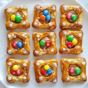 Here&rsquo;s what you need to make Christmas Pretzel Hugs. These treats are super simple and fun! - Square pretzels - Hershey's Hugs chocolates - Holiday-themed M&M's (red, green, white) - Sea salt Each ingredient plays a key role in the flavor and look of these treats. The square pretzels give a nice crunch. The Hershey's Hugs add creamy chocolate goodness. The colorful M&M's bring festive cheer. Finally, a sprinkle of sea salt gives that perfect sweet-and-salty mix. Gather these items before you start. It makes the cooking process smooth and quick. You can find all these ingredients at your local grocery store. Don't skip any! Each one helps create a magical holiday treat that everyone will love. {{ingredient_image_2}} Start by preheating your oven to 350&deg;F (175&deg;C). This heat helps the chocolates melt just right. Next, line a baking sheet with parchment paper. This step makes it easy to lift the treats off later. Now, take the square pretzels and place them on the lined baking sheet. Arrange them in a single layer. This way, they bake evenly. Next, grab a Hershey's Hug and place it on each pretzel. Center it well, so every bite has the perfect chocolate flavor. Put the baking sheet in your preheated oven for 4-5 minutes. Keep an eye on them! You want the chocolates to soften but not melt away. They should still look like hugs. After baking, take the sheet out of the oven. While the chocolates are warm, press a holiday-themed M&M into each Hug. This adds color and a tasty crunch! Let the pretzel hugs cool completely at room temperature. If you want to speed this up, place them in the fridge for 10-15 minutes. Finally, sprinkle a tiny pinch of sea salt on top for a sweet-and-salty treat. To make the best Christmas Pretzel Hugs, watch the chocolate closely while it melts. Set your timer for 4-5 minutes. Check the chocolate after 4 minutes. You want it soft but not fully melted. If it melts too much, it will lose its shape. For a fun display, use a bright holiday plate. Arrange the pretzel hugs in a circle or a festive pattern. Add ribbons around the plate for extra cheer. You can also place them in a colorful gift box. Garnish with sprigs of holly or festive decorations. When gifting these treats, use clear bags to show off the colors. Tie them with ribbon for a nice touch. You can also use a small box lined with tissue paper. Include a festive card to share your holiday wishes. These tips will make your treats feel special and fun! Pro Tips Use Fresh Ingredients: Ensure your pretzels and chocolates are fresh for the best flavor and texture in your treats. Watch the Oven: Keep a close eye on the chocolates while they&rsquo;re in the oven to prevent them from melting too much. Experiment with Toppings: Feel free to experiment with different types of candies or toppings to customize your pretzel hugs. Gift Idea: These pretzel hugs make a delightful homemade gift. Package them in a decorative jar or box for a personal touch! {{image_4}} You can switch up the chocolate for extra fun. Try using dark chocolate or white chocolate for a twist. Each type offers a unique taste. Dark chocolate adds a rich flavor, while white chocolate brings sweetness. You could even blend in flavored chocolates, like mint or caramel. This gives your pretzel hugs a tasty surprise! The colors of M&Ms can change the whole look. Use blue and silver for winter themes or pink and red for Valentine&rsquo;s Day. You can also use holiday-themed sprinkles for extra flair. Mixing different colors adds a fun touch. Get creative with shapes, too! Heart-shaped candies work great for special occasions. These treats are great for any holiday. For Halloween, use orange and black M&Ms. In the spring, pastel colors are perfect for Easter. You can even make them for birthdays by adding fun colors and shapes. Just adjust the M&M colors to match the theme. This way, your pretzel hugs are always festive! To keep your Christmas Pretzel Hugs fresh, place them in an airtight container. This helps maintain their taste and texture. Layer them with parchment paper to avoid sticking. You can store them at room temperature or in the fridge. These tasty treats can last up to two weeks when stored properly. If you keep them in the fridge, they may stay good for an extra week. Just make sure they are sealed tightly. You can freeze Christmas Pretzel Hugs for longer storage. Place them in a single layer on a baking sheet. Freeze for about an hour until firm. After that, transfer them to an airtight container or freezer bag. They can last up to three months in the freezer. When ready to enjoy, let them thaw at room temperature. Yes, you can use different chocolates. Milk chocolate or dark chocolate works well. You can also try flavored chocolates like peppermint or caramel. Just make sure they fit well on the pretzels. To make Christmas Pretzel Hugs gluten-free, choose gluten-free pretzels. They are easy to find in stores. Check the label to ensure they are certified gluten-free. The rest of the ingredients are naturally gluten-free. You can find pre-made Christmas Pretzel Hugs at many stores during the holidays. Look in the candy aisle or the bakery section. Online retailers also sell them, so you can order your favorites. These treats are great for many events! They work well for birthdays, parties, or school events. You can serve them for any festive gathering like Halloween or Valentine's Day. Yes, you can make these treats ahead of time! They stay fresh for a week in an airtight container. You can also freeze them for longer storage. Just let them thaw before serving. You now know how to make delicious Pretzel Hugs. We went over ingredients, step-by-step instructions, and helpful tips. You learned how to store them and even some fun variations. These treats are easy to make and great for sharing. Enjoy making your unique twists for every holiday! You&rsquo;ll impress everyone with your tasty creations.