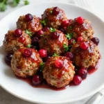 To make these tasty cranberry holiday meatballs, you need some key items: - 1 pound ground turkey (or chicken) - 1 cup breadcrumbs - 1/2 cup finely chopped onion - 1/4 cup fresh parsley, chopped - 1 large egg - 2 cloves garlic, minced - 1 teaspoon salt - 1/2 teaspoon black pepper - 1/2 teaspoon dried thyme - 1 cup canned whole berry cranberry sauce - 1 tablespoon soy sauce - 1 tablespoon Dijon mustard - 1 tablespoon brown sugar - 1 tablespoon apple cider vinegar These ingredients come together to create juicy meatballs with a sweet and tangy sauce. Adding some garnishes makes the dish look festive and bright. Consider these options: - Fresh cranberries - Extra parsley for a pop of color These simple touches help to make your meatballs even more inviting! You may already have some of these items in your pantry, which makes this recipe easy. Here’s a quick look: - Breadcrumbs: They add texture to the meatballs and help hold them together. - Soy Sauce: This adds a rich umami flavor to the sauce. - Dijon Mustard: It gives a nice tang to the sauce. - Brown Sugar: This balances the tartness of the cranberry sauce. These staples help create a flavor-packed dish that everyone will love. {{ingredient_image_2}} Start by preheating your oven to 400°F (200°C). Line a baking sheet with parchment paper. This helps the meatballs not stick. In a large bowl, add 1 pound of ground turkey or chicken. Then, add 1 cup of breadcrumbs and 1/2 cup of finely chopped onion. Next, mix in 1/4 cup of fresh parsley, 1 large egg, and 2 minced garlic cloves. Season your mix with 1 teaspoon of salt, 1/2 teaspoon of black pepper, and 1/2 teaspoon of dried thyme. Now, use your hands or a spoon to blend everything well. You want all the flavors to combine. Once mixed, the meat mixture should be moist, but not too wet. Now, shape the mixture into small meatballs. Aim for about 1 to 1.5 inches in diameter. This size cooks well and is easy to eat. Place the meatballs on your prepared baking sheet. Make sure they are spaced apart. Bake the meatballs for 18 to 20 minutes. They should be firm to touch and lightly browned. To check if they are done, you can cut one open. There should not be any pink inside. While the meatballs bake, let’s make the cranberry sauce. In a medium saucepan, combine 1 cup of canned whole berry cranberry sauce, 1 tablespoon of soy sauce, 1 tablespoon of Dijon mustard, 1 tablespoon of brown sugar, and 1 tablespoon of apple cider vinegar. Heat this mixture over medium heat. Stir it occasionally until it warms up. You want everything blended into a smooth sauce. Once the meatballs are baked, carefully add them to the saucepan. Gently toss the meatballs to coat them in the sauce. Now, your Cranberry Holiday Meatballs are ready to serve! To get the best meatballs, mix gently. If you overmix, they can be tough. Use your hands for a light touch. Aim for small, even meatballs about 1-1.5 inches wide. This size helps them cook evenly. For a richer sauce, add spices. A pinch of cinnamon or nutmeg gives warmth. If you like heat, try some red pepper flakes. You can also mix in a splash of orange juice for added brightness. Taste the sauce as it cooks. Adjust the flavors to your liking. Serve the meatballs in a festive dish. Use a platter for a beautiful display. Garnish with fresh cranberries and parsley. This gives a pop of color. Consider adding toothpicks for easy serving. It makes them fun to eat at parties! Pro Tips Use Fresh Ingredients: Always opt for fresh herbs and spices to enhance the flavor of your meatballs. Fresh parsley adds a vibrant taste compared to dried. Chill the Mixture: After mixing the meatball ingredients, refrigerate the mixture for about 30 minutes. This helps the meatballs hold their shape while baking. Adjust the Sweetness: Feel free to modify the amount of brown sugar in the sauce according to your taste preference. A little more can enhance the sweetness of the cranberry sauce. Garnish Creatively: For a beautiful presentation, use a mix of fresh herbs and cranberries to garnish. This not only adds color but also a festive touch to your dish. {{image_4}} You can easily swap ingredients to fit your dietary needs. If you want a gluten-free option, use gluten-free breadcrumbs. This keeps the meatballs tasty and safe for those with gluten issues. For a leaner choice, switch turkey for ground chicken. This also adds a different flavor while keeping it light. If you're vegan, try using a plant-based meat substitute. Just mix in the same spices and flavors as with meat. You can use different cooking methods for these meatballs. A slow cooker is great for a hands-off approach. Just mix everything, shape the meatballs, and place them in the slow cooker. Pour the sauce over them and cook on low for 6 hours or high for 3 hours. This keeps the meatballs tender and juicy. If you prefer an air fryer, set it to 375°F. Cook the meatballs for about 12-15 minutes. This method gives them a nice crispy edge. You can change the flavor of the meatballs easily. If you like heat, add red pepper flakes or chopped jalapeños to the meat mixture. This gives it a spicy kick. For a sweeter twist, mix in a bit more brown sugar or honey to the sauce. You can even add some orange zest for a fruity note. These changes make the dish fun and unique for your holiday table. To keep your leftover meatballs fresh, first let them cool. Place them in an airtight container. Store them in the fridge for up to three days. If you want them to last longer, freezing is a great option. To reheat the meatballs, you have a few choices. The oven is best for keeping them crispy. Preheat your oven to 350°F (175°C). Place the meatballs on a baking sheet. Heat them for about 10-15 minutes. You can also use the microwave. Just heat them for 1-2 minutes, checking often. If you plan to freeze the meatballs, do this before adding the sauce. Shape your meatballs and place them on a baking sheet. Freeze them for about an hour until firm. Then, transfer them to a freezer bag. They can stay in the freezer for up to three months. When you are ready to use them, thaw them in the fridge overnight before cooking. Yes, you can use beef or pork. Each meat brings a different flavor. Beef makes the meatballs rich and hearty. Pork adds a touch of sweetness. Make sure to adjust cooking times as needed. Ground turkey is leaner, so it cooks faster. Be mindful of the fat content in beef or pork. To check if the meatballs are done, look for a few signs. They should be firm to the touch and no longer pink inside. You can also use a meat thermometer. The internal temperature should reach 165°F (74°C). If you’re unsure, cut one in half. Check that it’s fully cooked and hot. Cranberry holiday meatballs pair well with many sides. Consider serving them with rice or mashed potatoes. They also go great with a fresh salad. For a festive touch, serve with roasted vegetables. If you want something easy, use toothpicks for serving. This makes them perfect for parties or gatherings. Cranberry holiday meatballs are simple and tasty. We covered key ingredients and made cooking easy. You learned how to prepare, bake, and sauce them for the best flavor. I shared tips for texture and serving. We also looked at variations for special diets and storage tips for leftovers. In short, these meatballs are fun and festive. Enjoy making them for your next gathering!