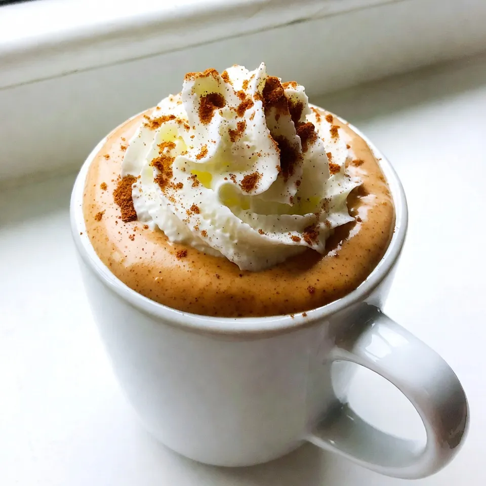 To make a tasty Pumpkin Spice Eggnog, you need these main ingredients: - 2 cups whole milk - 1 cup heavy cream - 3/4 cup pumpkin puree - 1/2 cup granulated sugar - 4 large egg yolks - 1 teaspoon vanilla extract - 1 teaspoon ground cinnamon - 1/2 teaspoon ground nutmeg - 1/4 teaspoon ground ginger These items create a rich and creamy base. The pumpkin puree gives it that warm fall flavor. The spices add depth, making each sip delightful. You can also try these optional ingredients to mix things up: - Almond milk (for a lighter version) - Coconut milk (for a tropical twist) - Maple syrup (as a natural sweetener) - Whipped topping (for extra creaminess) Using these substitutes can change the taste. They can also suit different dietary needs. To make your eggnog look and taste even better, consider these garnishes: - Whipped cream (for a fluffy top) - Ground cinnamon (for a spicy finish) - Nutmeg (for a classic touch) - Crushed graham crackers (for a crunchy texture) These toppings add a nice touch. They can make your drink festive and fun! {{ingredient_image_2}} To make pumpkin spice eggnog, start by warming 2 cups of whole milk and 1 cup of heavy cream in a medium saucepan. Heat it on medium until it’s warm, about 150°F. Stir it gently, but do not let it boil. In a separate bowl, mix 3/4 cup of pumpkin puree, 1/2 cup of granulated sugar, and 4 large egg yolks. Add 1 teaspoon of vanilla extract, 1 teaspoon of ground cinnamon, 1/2 teaspoon of ground nutmeg, and 1/4 teaspoon of ground ginger. Whisk these ingredients until smooth. Next, slowly pour the warm milk and cream into the pumpkin mix while whisking. This helps the eggs warm up without curdling. Once combined, pour the mixture back into the saucepan. Cook it over low heat, stirring constantly for about 5-7 minutes. You want it to thicken enough to coat the back of a spoon. Avoid boiling it, as this can ruin the texture. Make sure to heat the milk and cream slowly. If it gets too hot, it can boil, which is not good. When mixing the warm liquid with the egg mixture, whisk continuously. This step is key to prevent the eggs from cooking too fast and turning into scrambled eggs. Keep stirring while cooking on low heat. This helps the eggnog thicken evenly. If you stop stirring, it can stick to the bottom of the pan and burn. After thickening, take the saucepan off the heat and let the eggnog cool for about 15 minutes at room temperature. Then, strain it through a fine-mesh sieve into a bowl or pitcher. This step ensures a smooth drink by removing lumps. Chill the strained eggnog in the fridge for at least 2-3 hours. Once it’s fully cold, serve it in festive glasses. Top each serving with whipped cream and a sprinkle of ground cinnamon for a lovely finish. Enjoy the delicious, spiced flavor! To get a silky smooth pumpkin spice eggnog, use these tips: - Heat slowly: Warm the milk and cream gently. Stir often to prevent scorching. - Whisk well: Blend the pumpkin puree and egg yolks until creamy. This mixes air in. - Temper the eggs: Pour warm milk into the pumpkin mix slowly while whisking. This keeps the eggs from cooking too fast. Here are a few common hiccups to avoid: - Do not boil: Boiling the mixture can turn it grainy. Keep the heat low and steady. - Watch the time: Stir the mixture constantly while it thickens. This takes about 5-7 minutes. - Strain carefully: Use a fine-mesh sieve to catch lumps. This step is key for smoothness. You can make this eggnog your own by adjusting flavors: - Sweetness: Start with 1/2 cup of sugar. Taste it, and add more if you like. - Spices: For more warmth, add extra cinnamon or nutmeg. Start with 1/4 teaspoon more. - Pumpkin puree: For a stronger pumpkin flavor, increase the puree to 1 cup. Feel free to play around with these ideas to make your perfect pumpkin spice eggnog! Pro Tips Use Fresh Pumpkin Puree: For the best flavor, opt for homemade pumpkin puree instead of canned. It enhances the taste and freshness of your eggnog. Whisk Constantly: When combining the warm milk with the egg mixture, whisk continuously to prevent the eggs from curdling. This ensures a smooth and creamy texture. Chill Thoroughly: Allow the eggnog to chill in the fridge for at least 2-3 hours. This not only improves the flavor but also ensures it’s refreshing when served. Garnish Creatively: Elevate your presentation by garnishing with whipped cream and a sprinkle of ground cinnamon or even a cinnamon stick for added flair. {{image_4}} You can easily make a dairy-free version of pumpkin spice eggnog. Use almond milk or coconut milk instead of whole milk. For creaminess, opt for canned coconut cream. Replace egg yolks with silken tofu or a banana. This keeps the rich texture. Sweeten it with maple syrup or agave nectar. Add your spices for flavor, and enjoy a vegan treat. If you want to add a kick, try spiking your eggnog. Rum or bourbon works well here. Add about 1 cup of your chosen spirit to the mix. This gives the drink a warm, cozy vibe. You can also try flavored liqueurs like butterscotch. This adds a new taste dimension. Just remember to adjust sweetness as needed. Feel free to get creative with flavors! For a chocolate twist, mix in chocolate syrup or cocoa powder. Start with 1 to 2 tablespoons. If you prefer caramel, drizzle some caramel sauce into the mix. This adds sweetness and a rich flavor. You can also blend in a pinch of espresso powder for a coffee kick. Each of these options makes your eggnog unique and fun! To store leftover Pumpkin Spice Eggnog, you need a clean, sealed container. A glass jar or a plastic pitcher works well. Pour the eggnog into the container and close it tightly. Place it in the fridge. This keeps the eggnog fresh and safe to drink. You can freeze Pumpkin Spice Eggnog, but it may change texture. To freeze, pour eggnog into freezer-safe bags. Leave some space for expansion. When ready to use, thaw the eggnog in the fridge overnight. Stir well before serving, as it may separate. Pumpkin Spice Eggnog lasts about 3-5 days in the fridge. If you freeze it, it can last up to 3 months. Always check for any off smell or changes in texture before drinking. If you see any signs of spoilage, it's best to toss it out. Enjoy your eggnog safely! Eggnog has a long history. It dates back to the 14th century. Early forms included milk, eggs, and alcohol. This drink was popular among the rich. It often appeared at holiday feasts. The name “eggnog” likely comes from two words: “egg” and “noggin,” a small cup. Over time, it became a holiday favorite for many. Yes, you can use pumpkin pie spice. It combines cinnamon, nutmeg, and ginger. This makes it easy to add flavor. Use about 2 teaspoons of pumpkin pie spice. Adjust based on your taste. It simplifies the recipe while keeping it tasty. You can make Pumpkin Spice Eggnog a day ahead. Follow the recipe and chill it. Store it in a pitcher in the fridge. This allows the flavors to blend well. Just remember to stir before serving. Garnish with whipped cream and cinnamon. Enjoy it cold and festive! This blog post covered how to make Pumpkin Spice Eggnog using key ingredients and steps. You learned about optional elements and garnishes that can enhance your drink. I shared tips for smooth texture and customization. We explored variations, including dairy-free options and flavor boosts. Lastly, I provided storage information to keep your eggnog fresh. Enjoying your homemade eggnog can be a festive treat. Follow these steps to impress your friends and family!